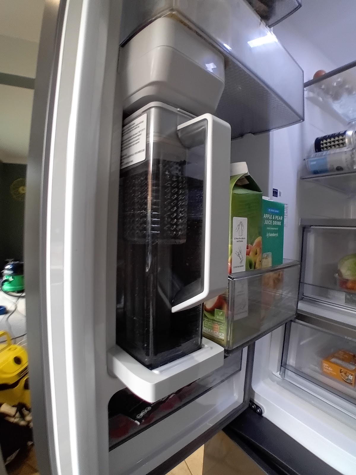American style fridge freezer door open showing water filter unit